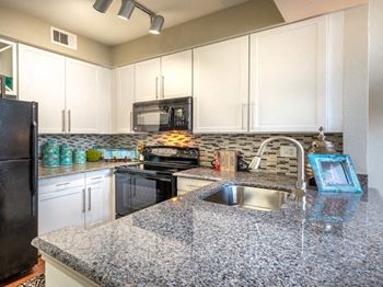 Upscale kitchen featuring granite countertops